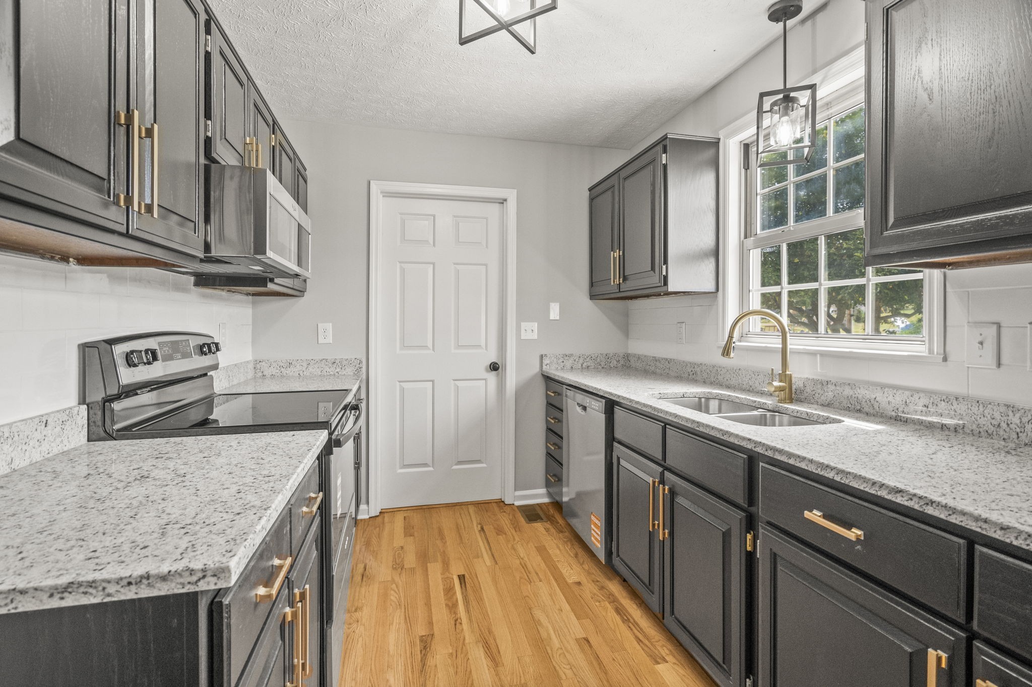 8861 Owens Chapel Road Springfield, TN 37172 - Photo 9 of 22 a kitchen with stainless steel appliances granite countertop a sink stove and cabinets