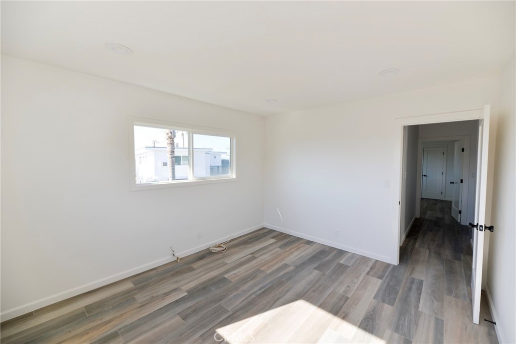 262 Avenida Victoria, Unit 4 San Clemente, CA 92672 - Photo 18 of 24 an empty room with wooden floor and windows
