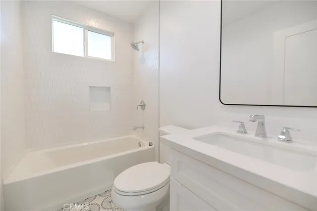 a bathroom with a sink a toilet and a bathtub