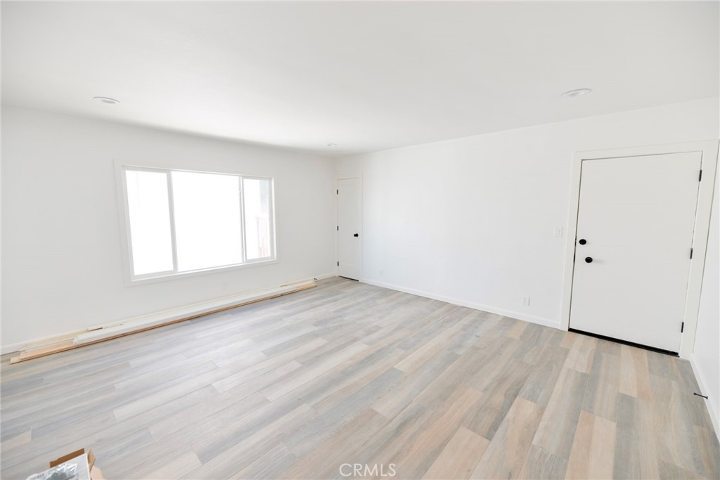 262 Avenida Victoria, Unit 4 San Clemente, CA 92672 - Photo 4 of 24 an empty room with wooden floor and windows