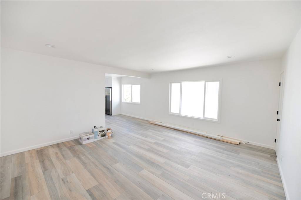 262 Avenida Victoria, Unit 4 San Clemente, CA 92672 - Photo 5 of 24 an empty room with wooden floor and windows