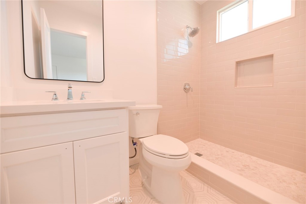 262 Avenida Victoria, Unit 4 San Clemente, CA 92672 - Photo 10 of 24 a bathroom with a toilet a sink and mirror