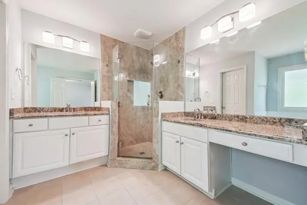 a bathroom with a granite countertop sink mirror and a