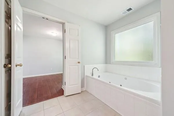 a bathroom with a bathtub and a shower