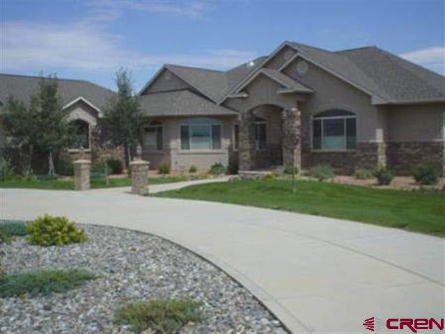2410 Red Ranch Drive Grand Junction, CO 81505 - Photo 1 of 1 a front view of a house with a yard and garage