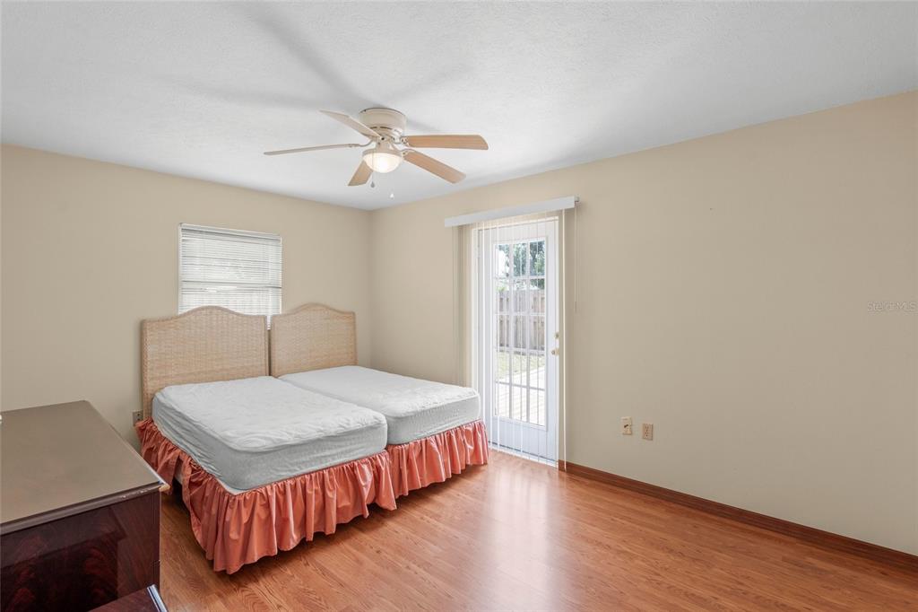 1036 Hope Street Venice, FL 34285 - Photo 11 of 41 a bedroom with a bed and wooden floor