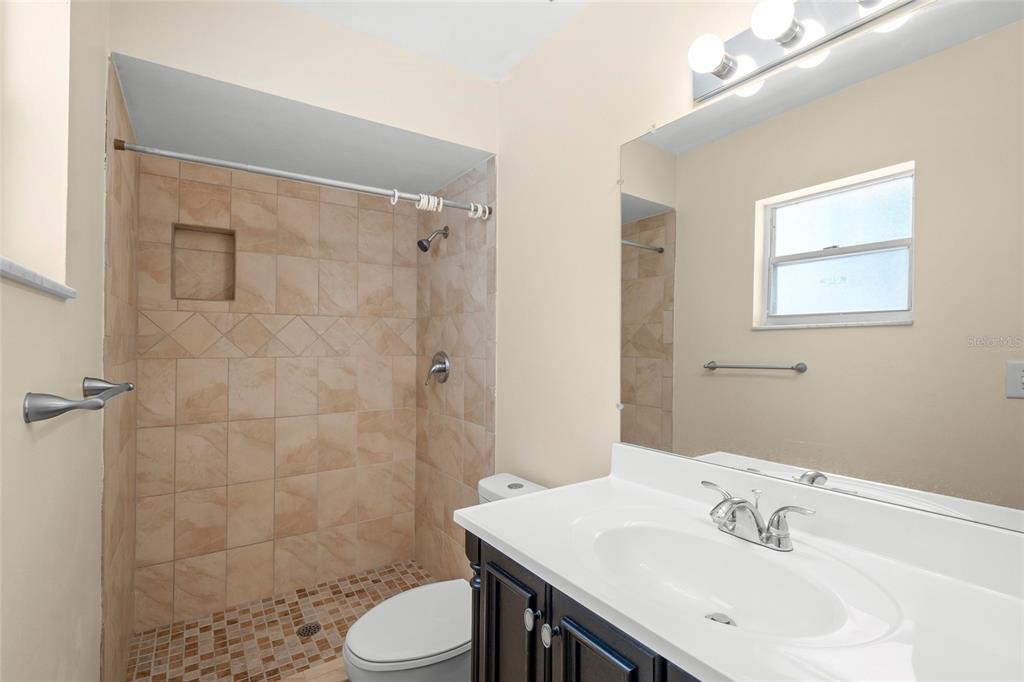 1036 Hope Street Venice, FL 34285 - Photo 14 of 41 a bathroom with a sink toilet and shower