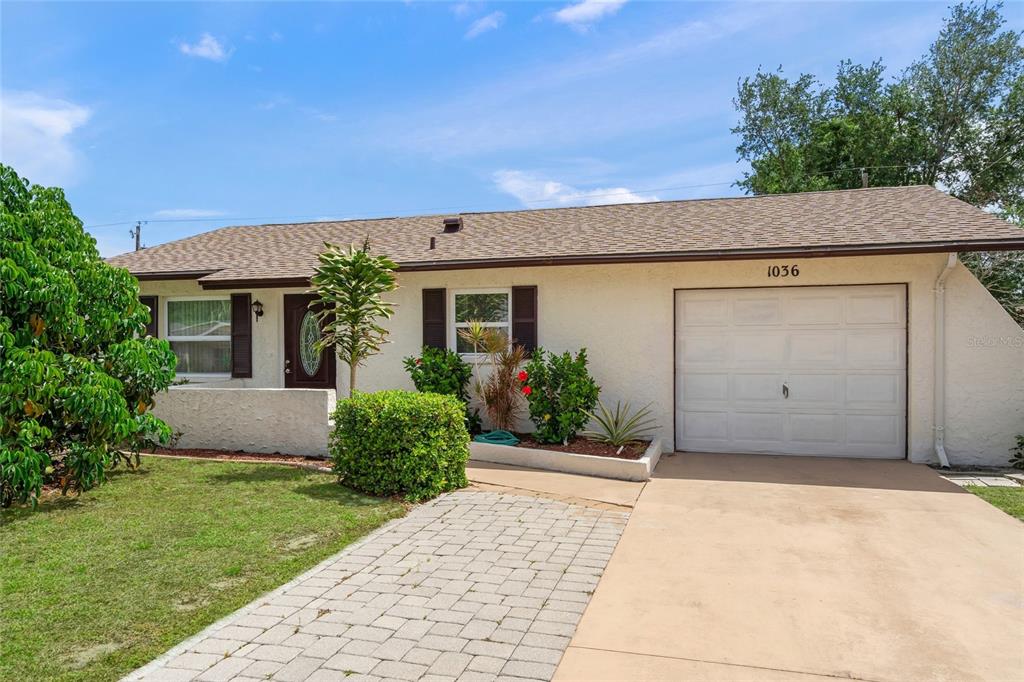 1036 Hope Street Venice, FL 34285 - Photo 2 of 41 a front view of a house with a garden