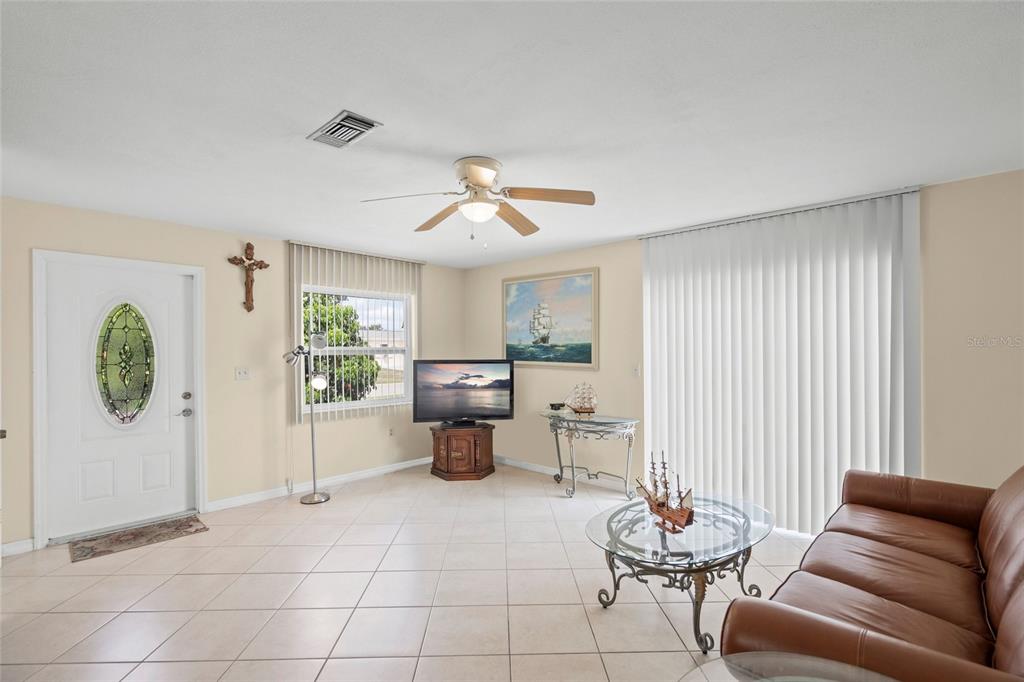1036 Hope Street Venice, FL 34285 - Photo 3 of 41 a living room with furniture a window and a chandelier
