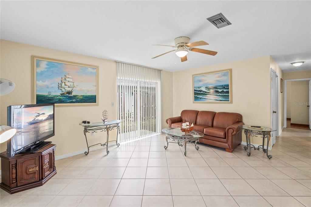 1036 Hope Street Venice, FL 34285 - Photo 4 of 41 a living room with furniture and a flat screen tv