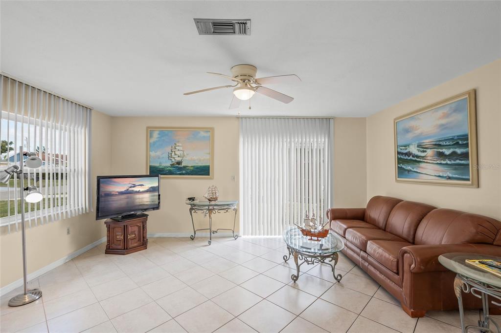 1036 Hope Street Venice, FL 34285 - Photo 5 of 41 a living room with furniture and a flat screen tv