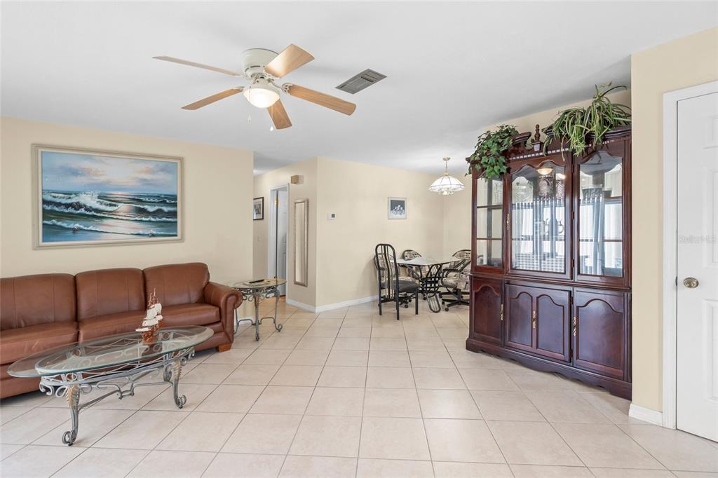 1036 Hope Street Venice, FL 34285 - Photo 6 of 41 a living room with furniture a chandelier and a dining table