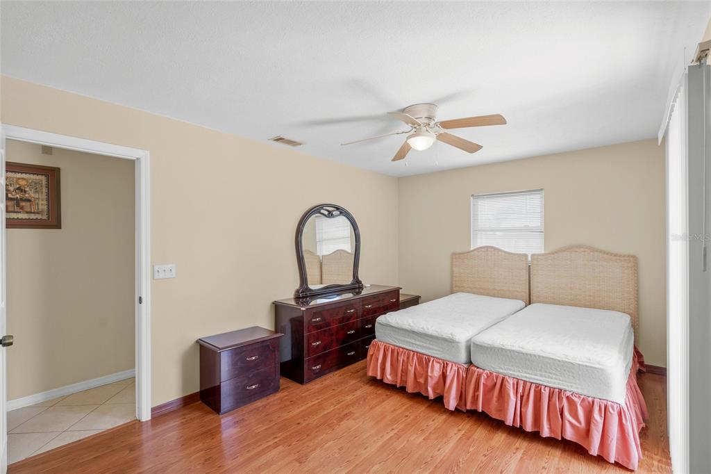 1036 Hope Street Venice, FL 34285 - Photo 10 of 41 a bedroom with a bed and a chandelier