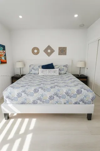 a bathroom with a granite countertop toilet sink mirror and vanity