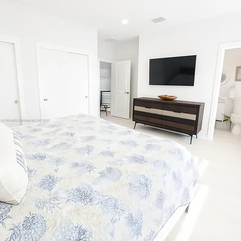 a bedroom with a bed and a couch