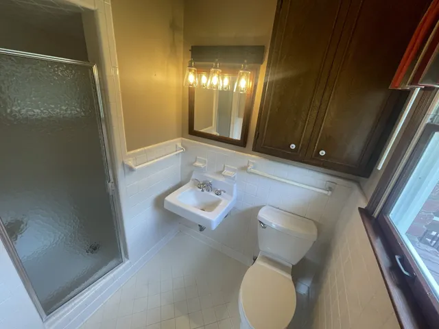 a bathroom with a toilet sink and mirror