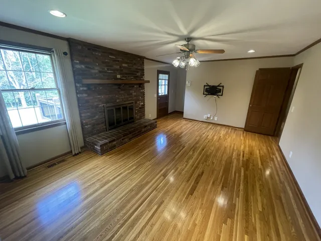 wooden floor in an empty room with a fireplace