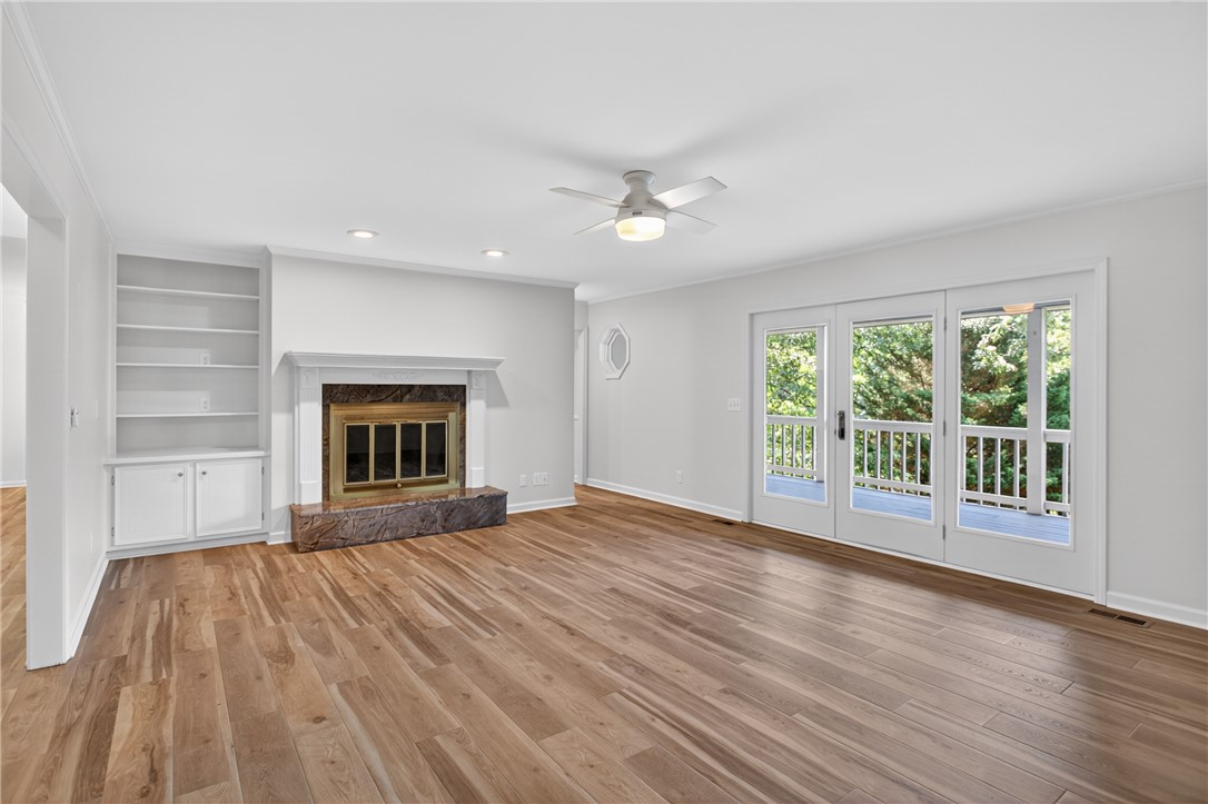 9 Lookout Lane Salem, SC 29676 - Photo 8 of 46 A refined living space showcases gleaming hardwood flooring, a warm fireplace with a decorative mantel, and French doors leading to outdoor serenity.
