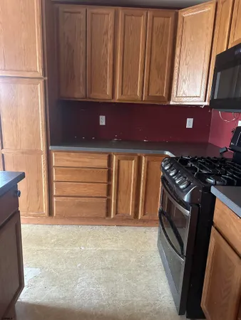 a kitchen with stainless steel appliances a microwave a sink and cabinets