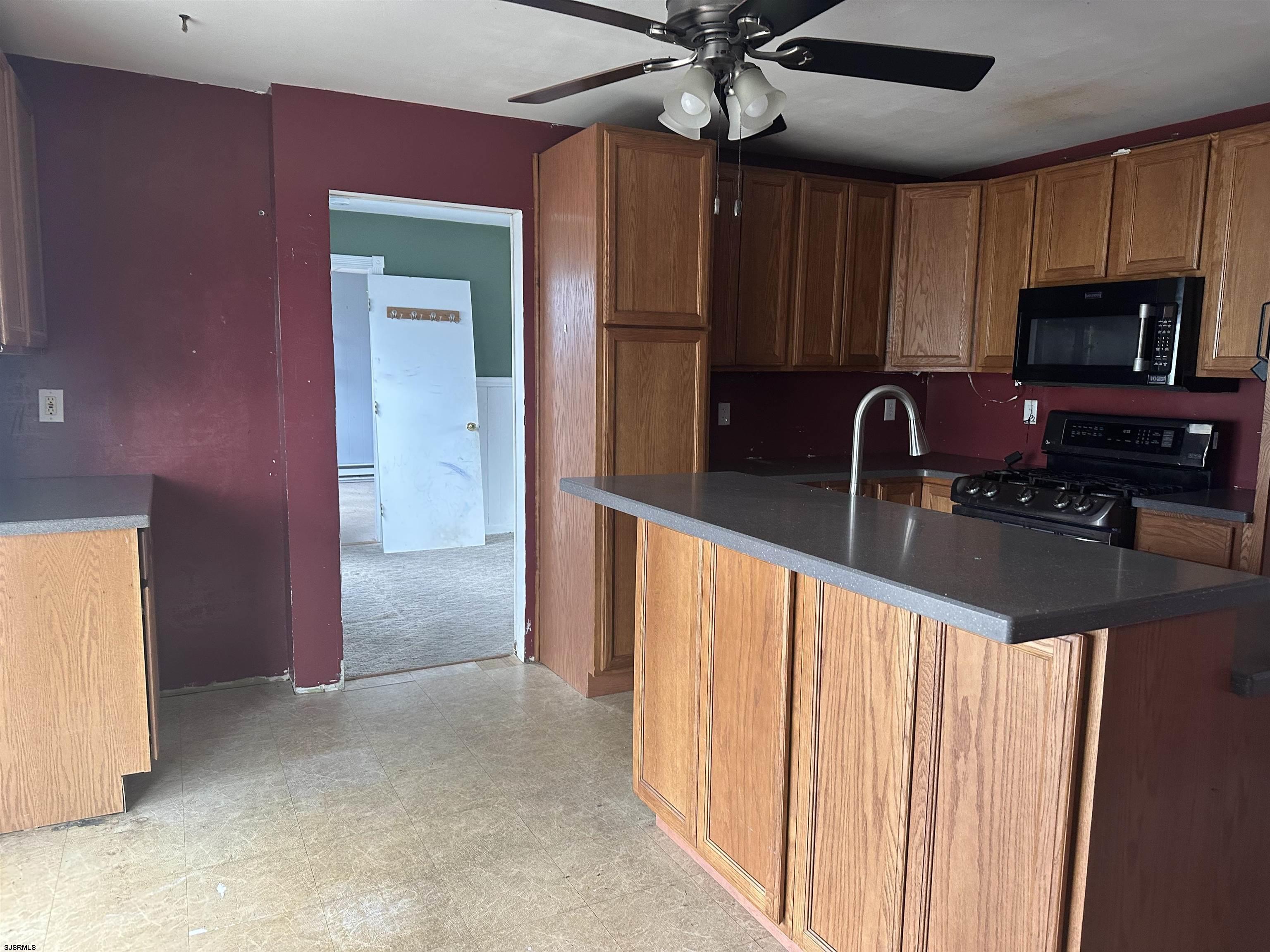 968 Hazelwood Road Toms River, NJ 08753 - Photo 14 of 25 a kitchen with stainless steel appliances a microwave a sink and cabinets