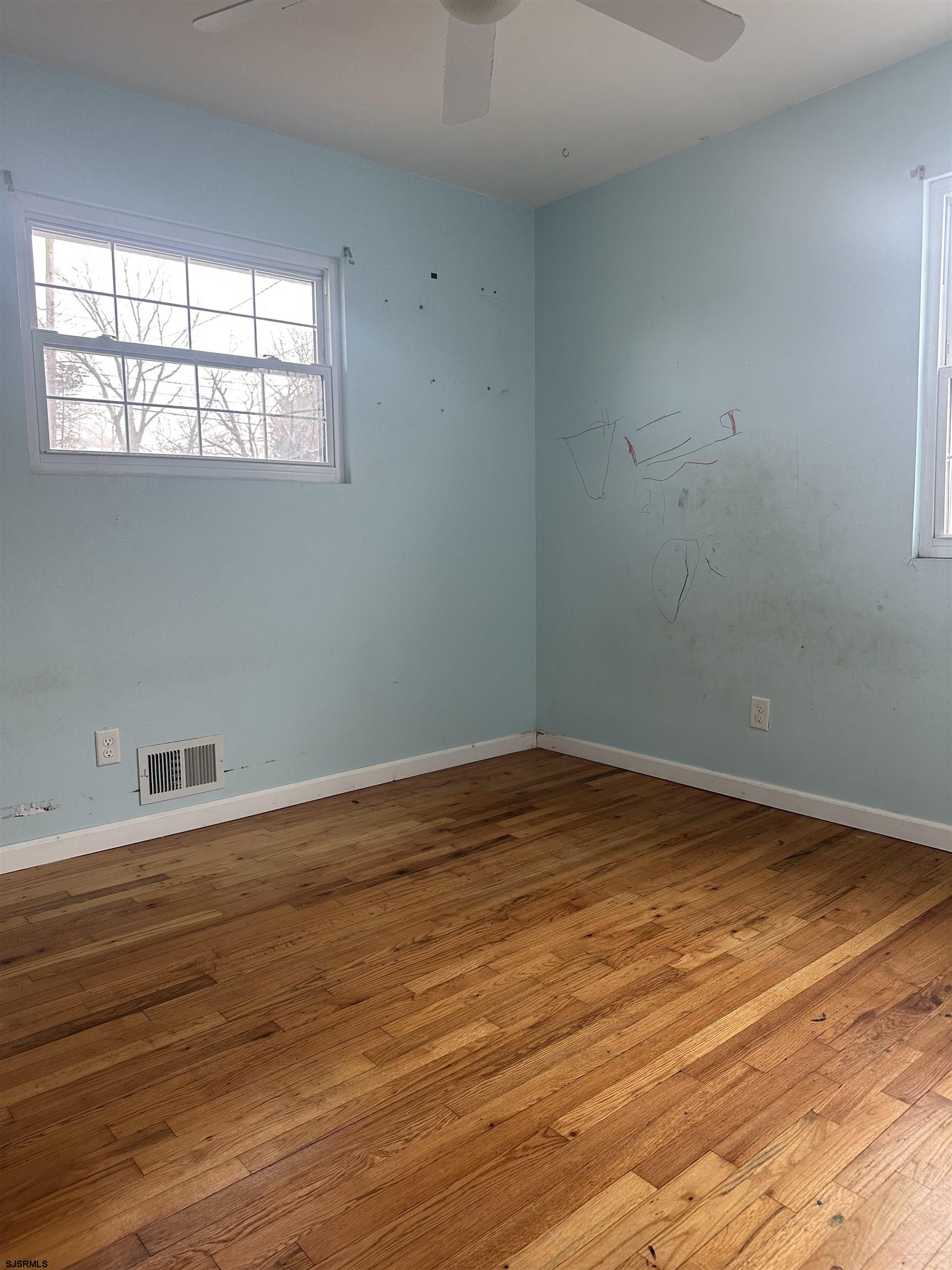 968 Hazelwood Road Toms River, NJ 08753 - Photo 20 of 25 an empty room with wooden floor and windows