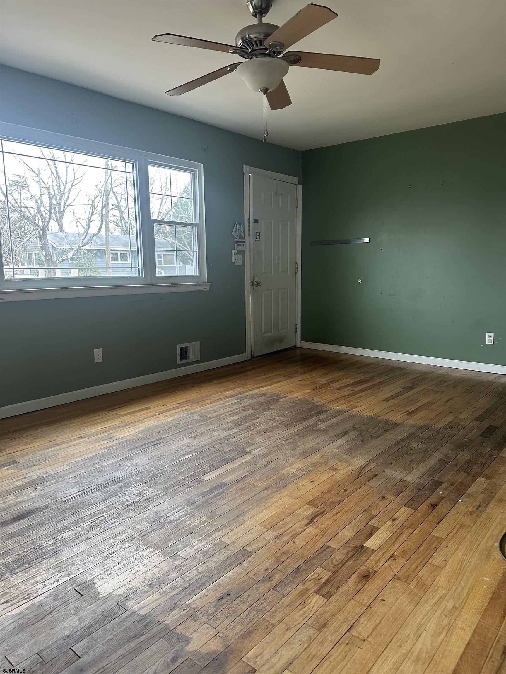 968 Hazelwood Road Toms River, NJ 08753 - Photo 5 of 25 an empty room with wooden floor and windows