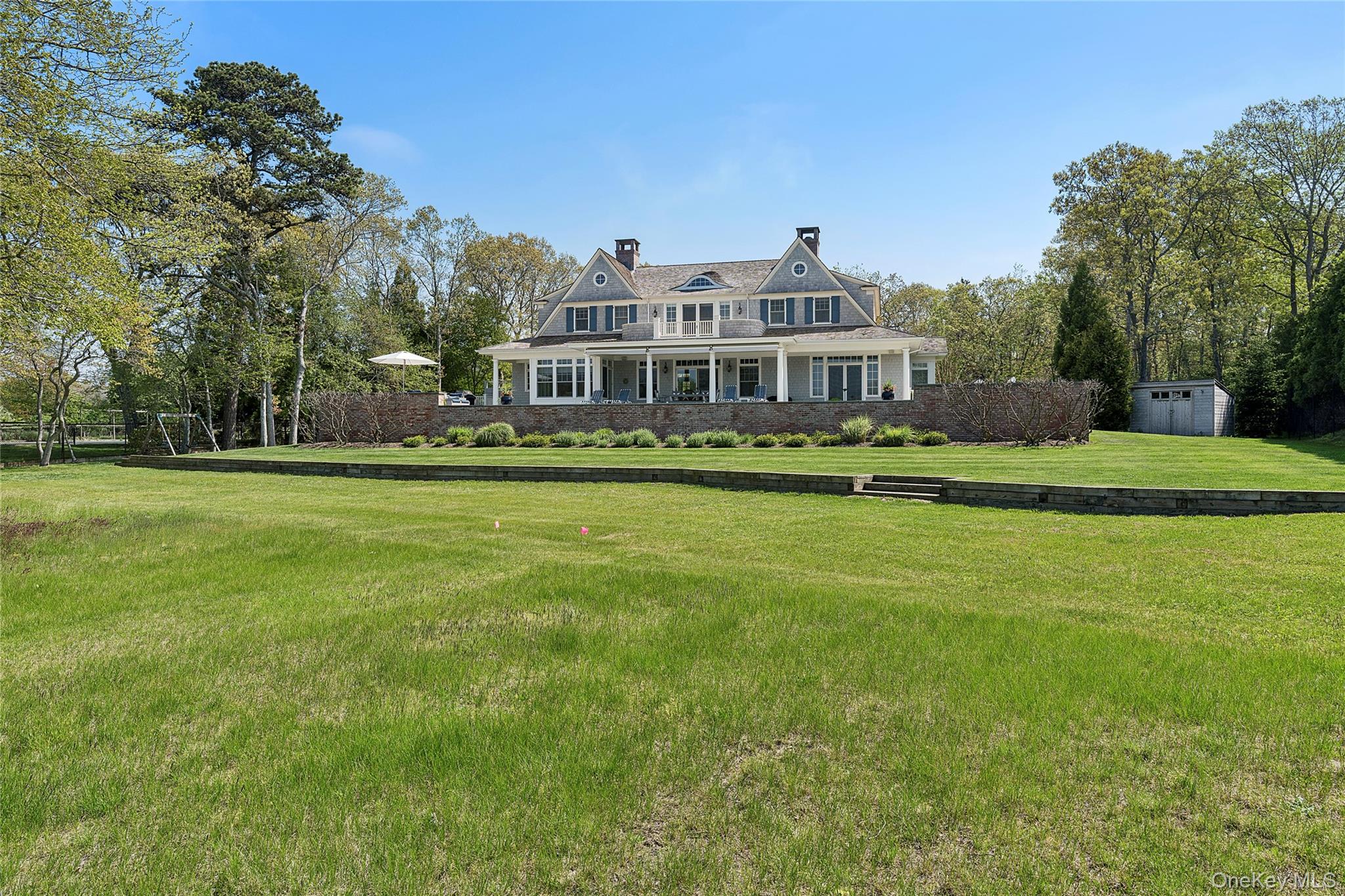 43 Old Main Road Quogue, NY 11959 - Photo 26 of 28 a front view of a house with a garden