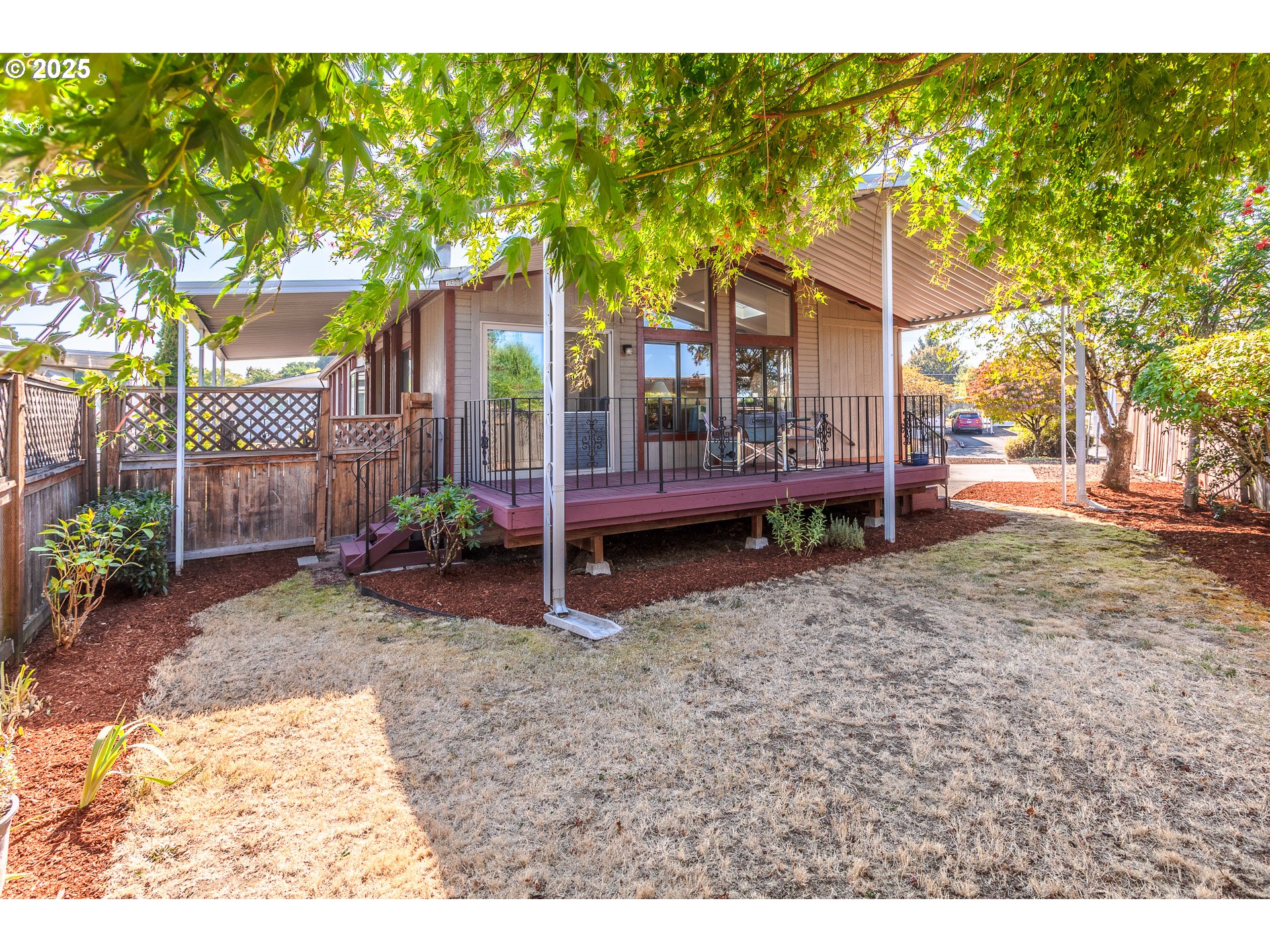 a backyard of a house with barbeque oven table and chairs