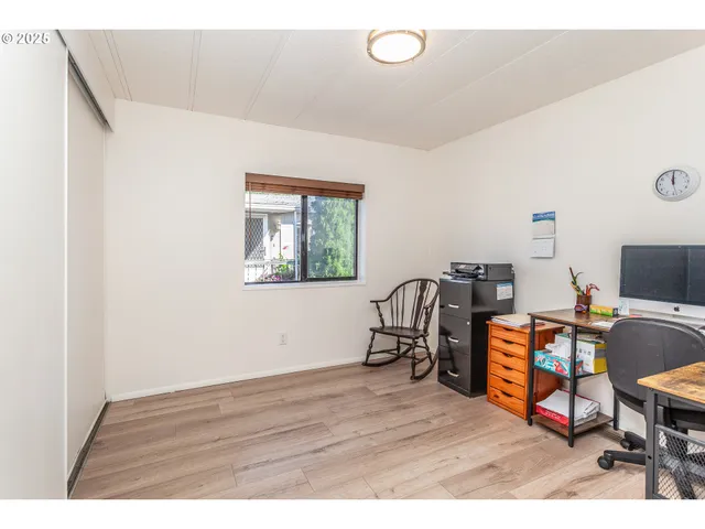a kitchen with a sink cabinets and wooden floor