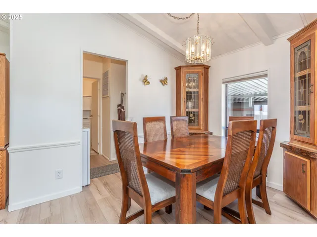 a view of a dining room with furniture and a book shelf