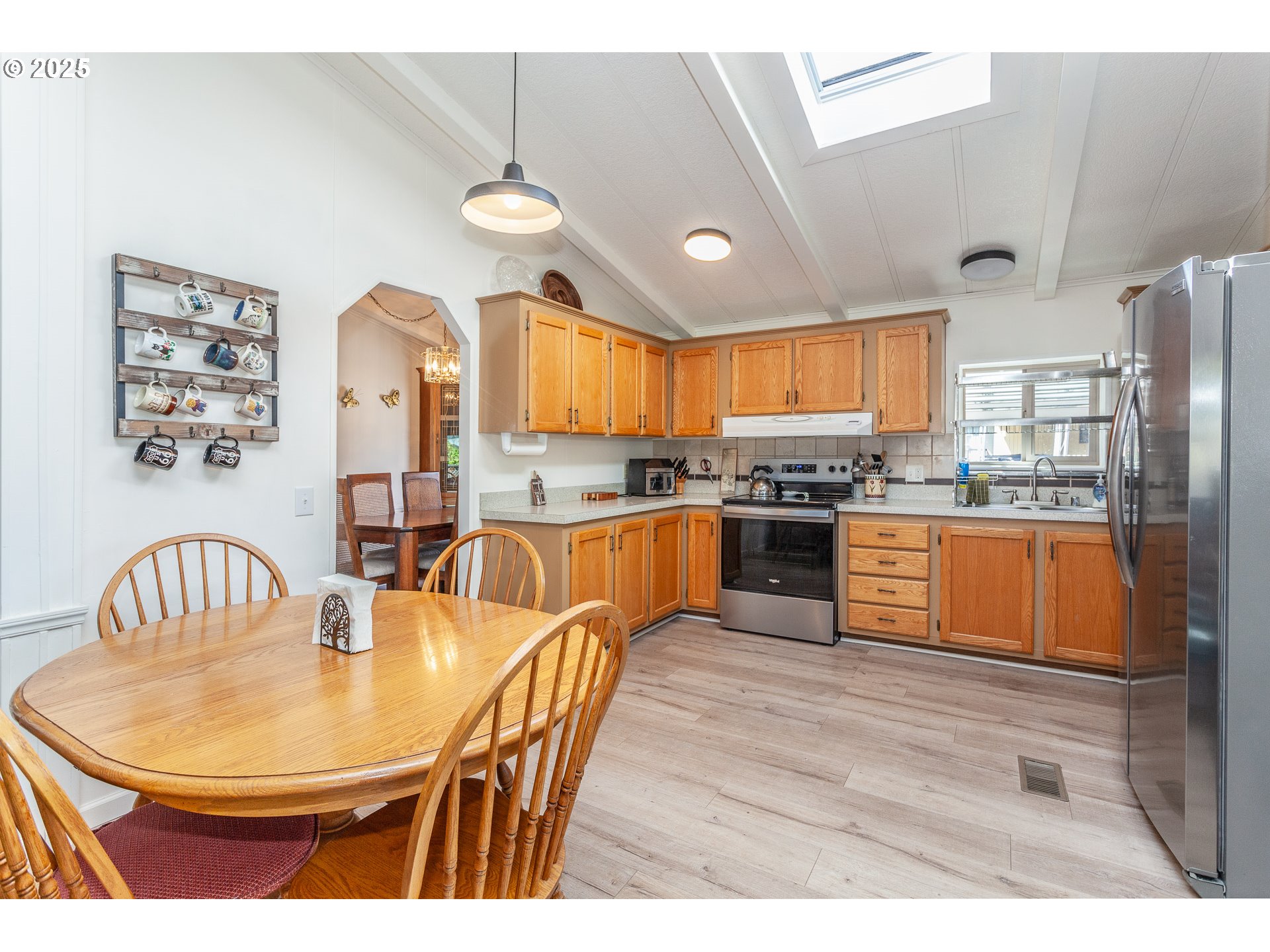 7455 Southeast King Road, Unit 53 Milwaukie, OR 97222 - Photo 10 of 33 a kitchen with stainless steel appliances granite countertop a sink a stove a dining table and chairs
