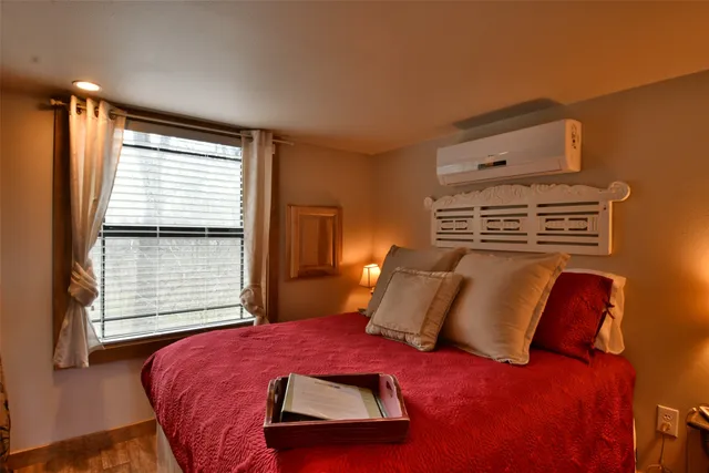 a bedroom with a bed and a window