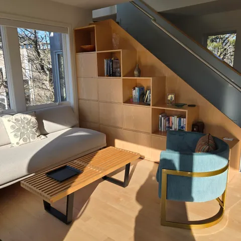 a bedroom with two beds and a chair