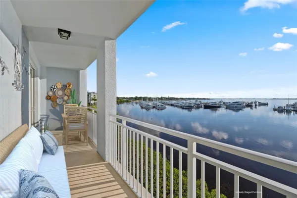 a view of a balcony with lake view and wooden floor