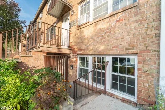 a view of a brick house with a large windows