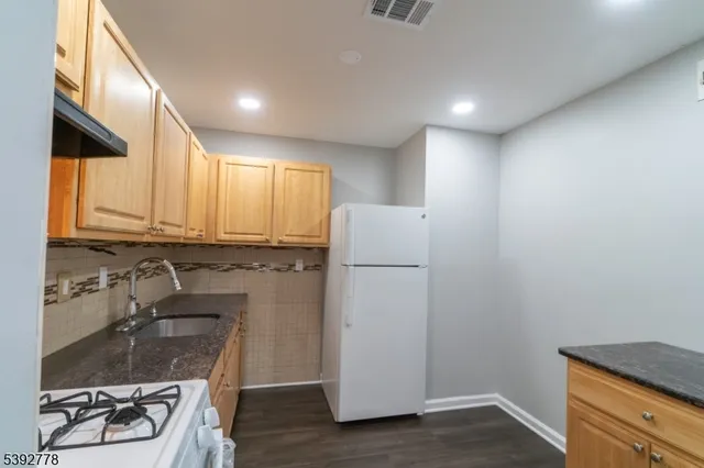 a kitchen with a sink appliances and cabinets