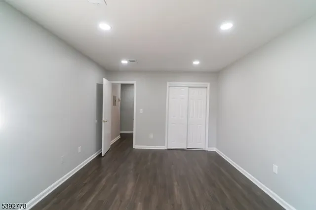 a view of hallway with wooden floor