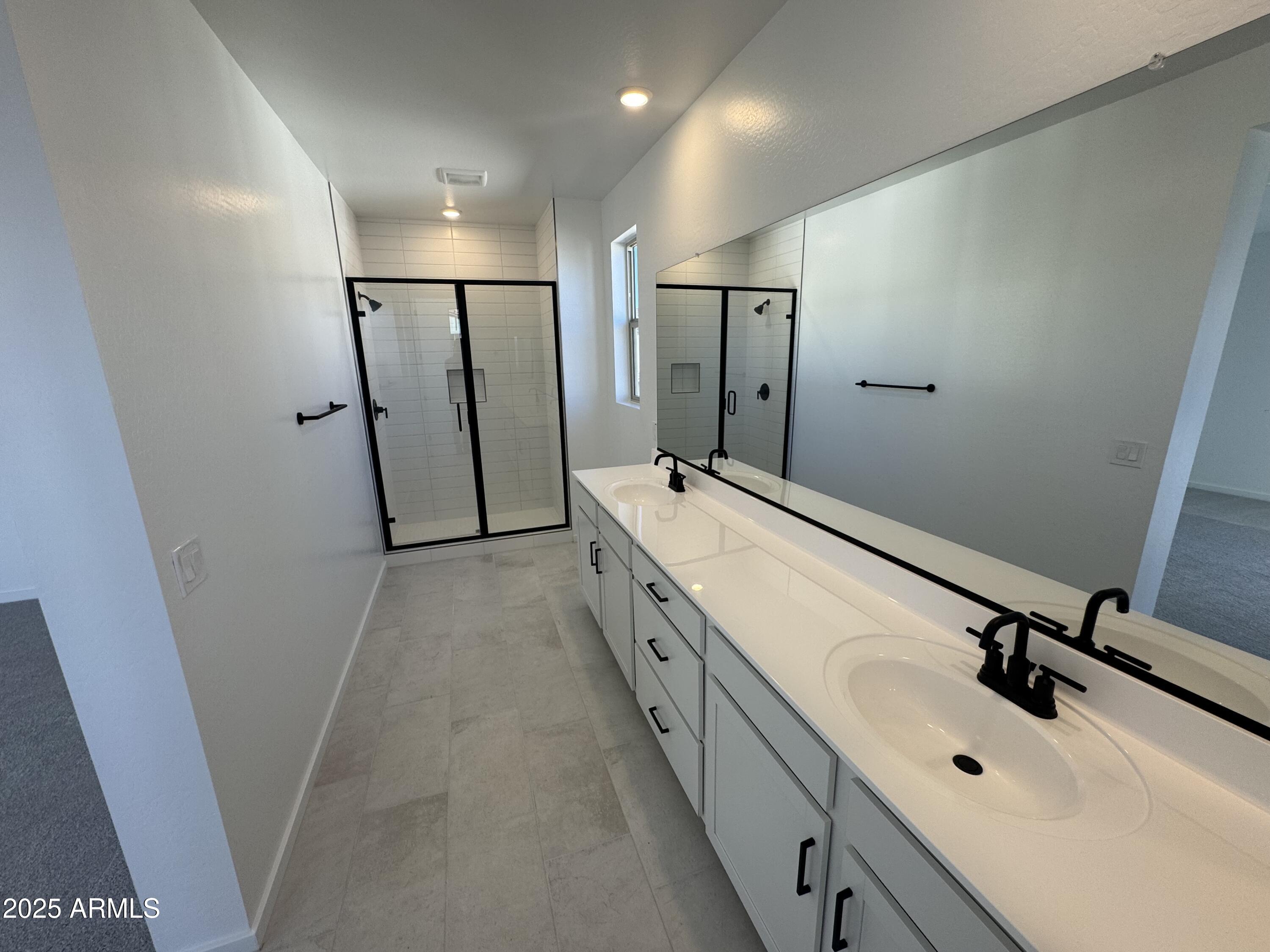 2454 West Maximo Way Phoenix, AZ 85085 - Photo 12 of 27 a spacious bathroom with a double vanity sink a mirror and a shower