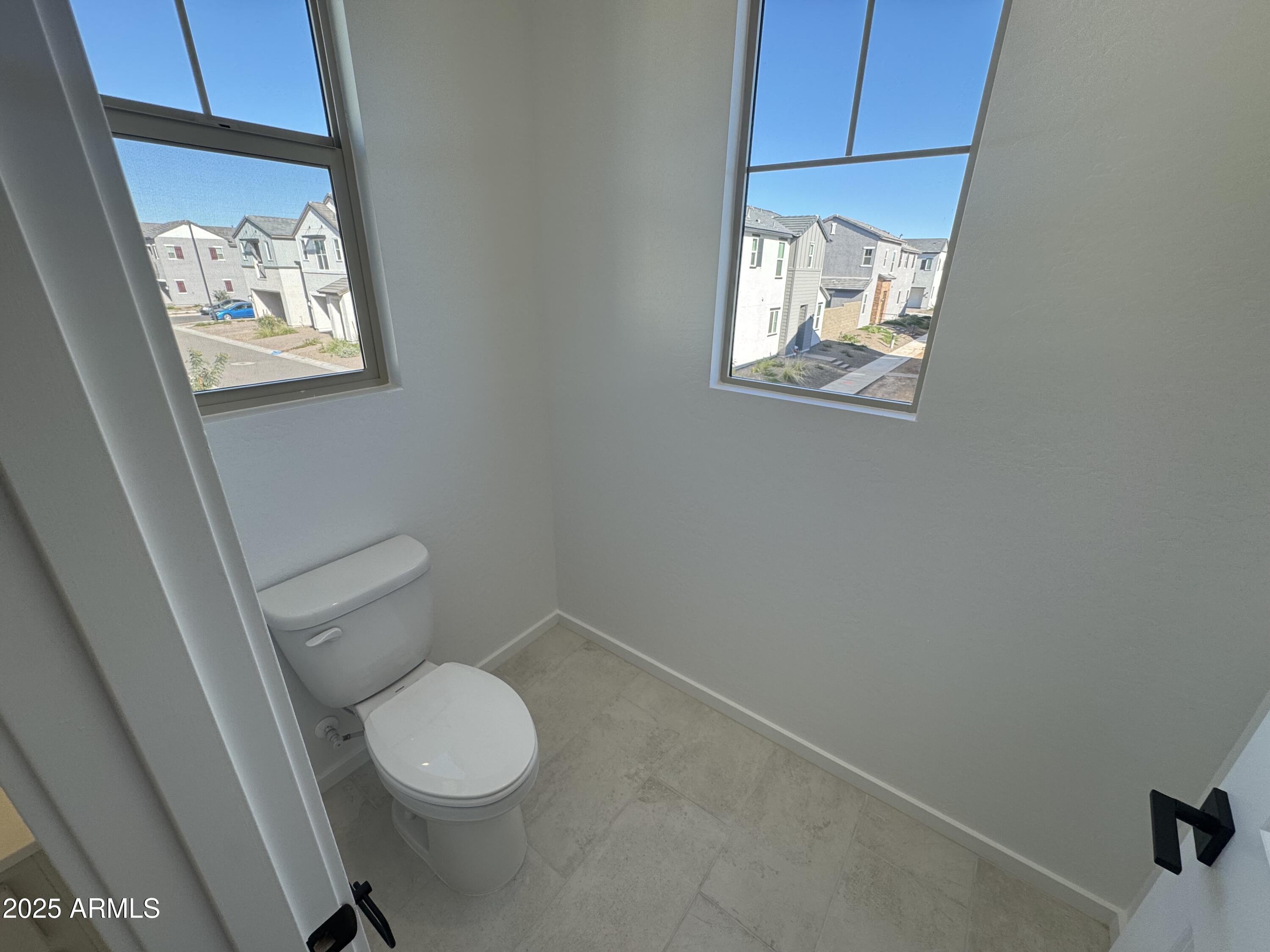 2454 West Maximo Way Phoenix, AZ 85085 - Photo 16 of 27 a white toilet sitting next to a bathroom sink
