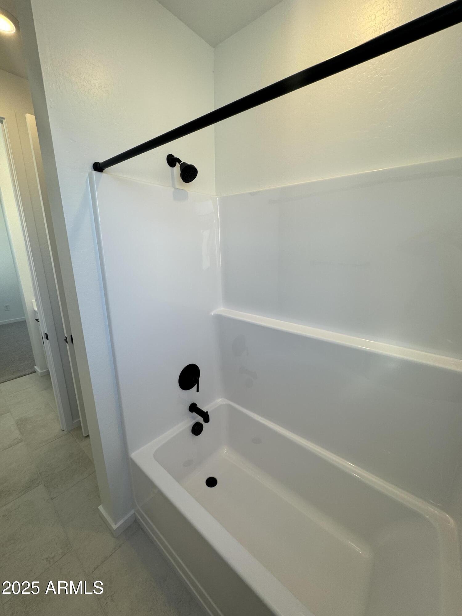 2454 West Maximo Way Phoenix, AZ 85085 - Photo 19 of 27 a bathroom with a tub and a shower