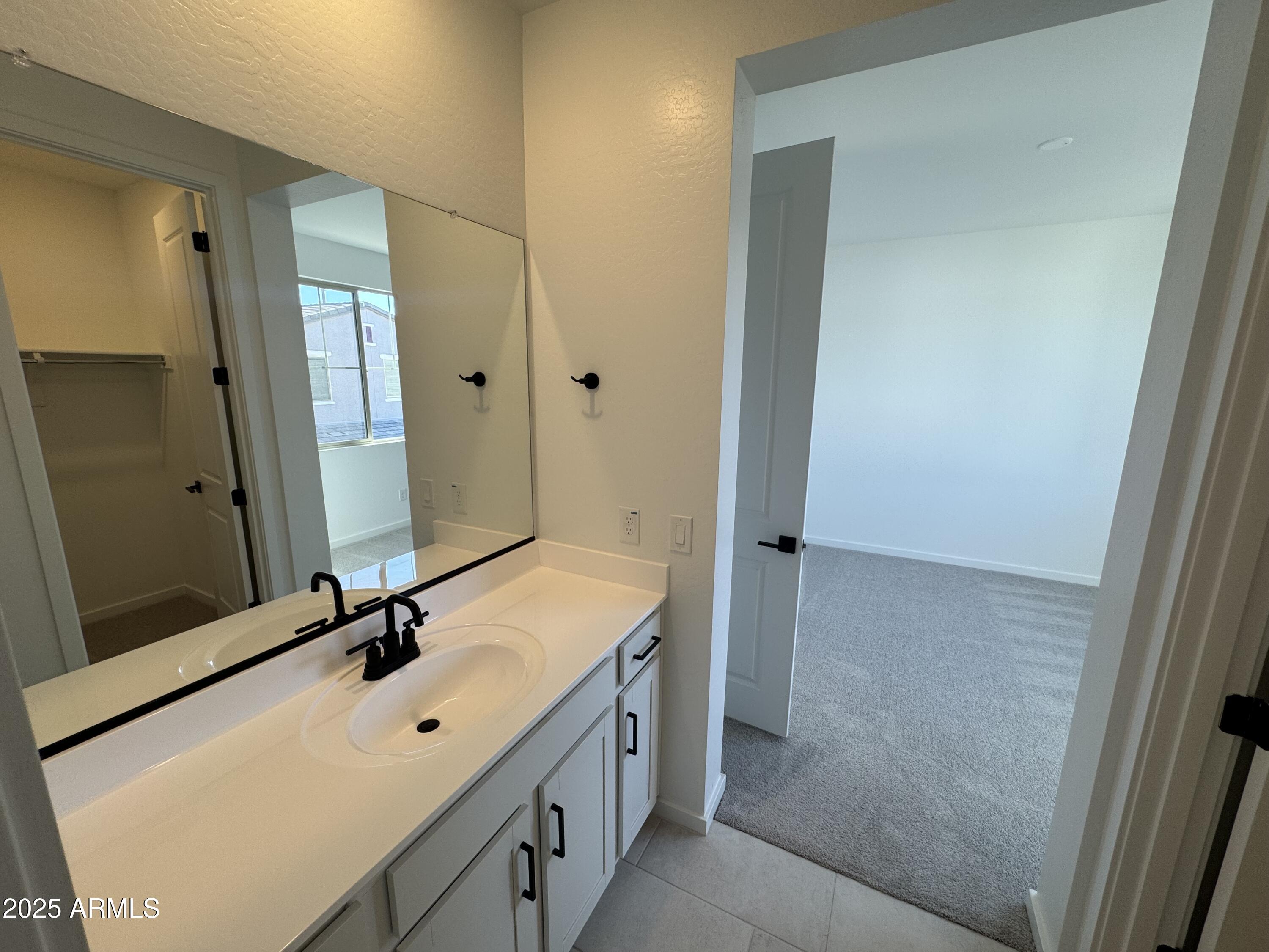 2454 West Maximo Way Phoenix, AZ 85085 - Photo 21 of 27 a bathroom with a double vanity sink and a mirror