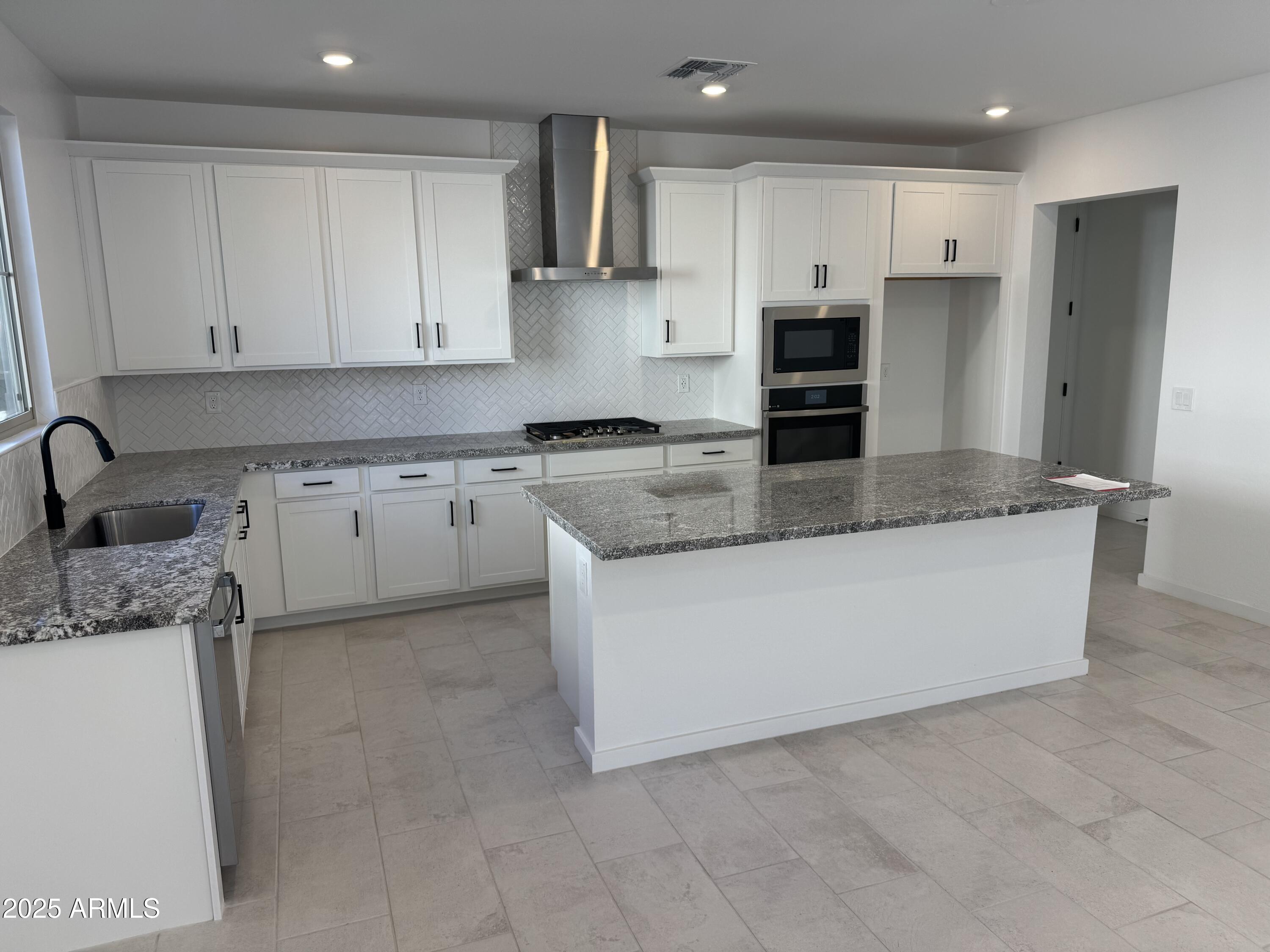 2454 West Maximo Way Phoenix, AZ 85085 - Photo 3 of 27 a kitchen with stainless steel appliances granite countertop a sink and a stove