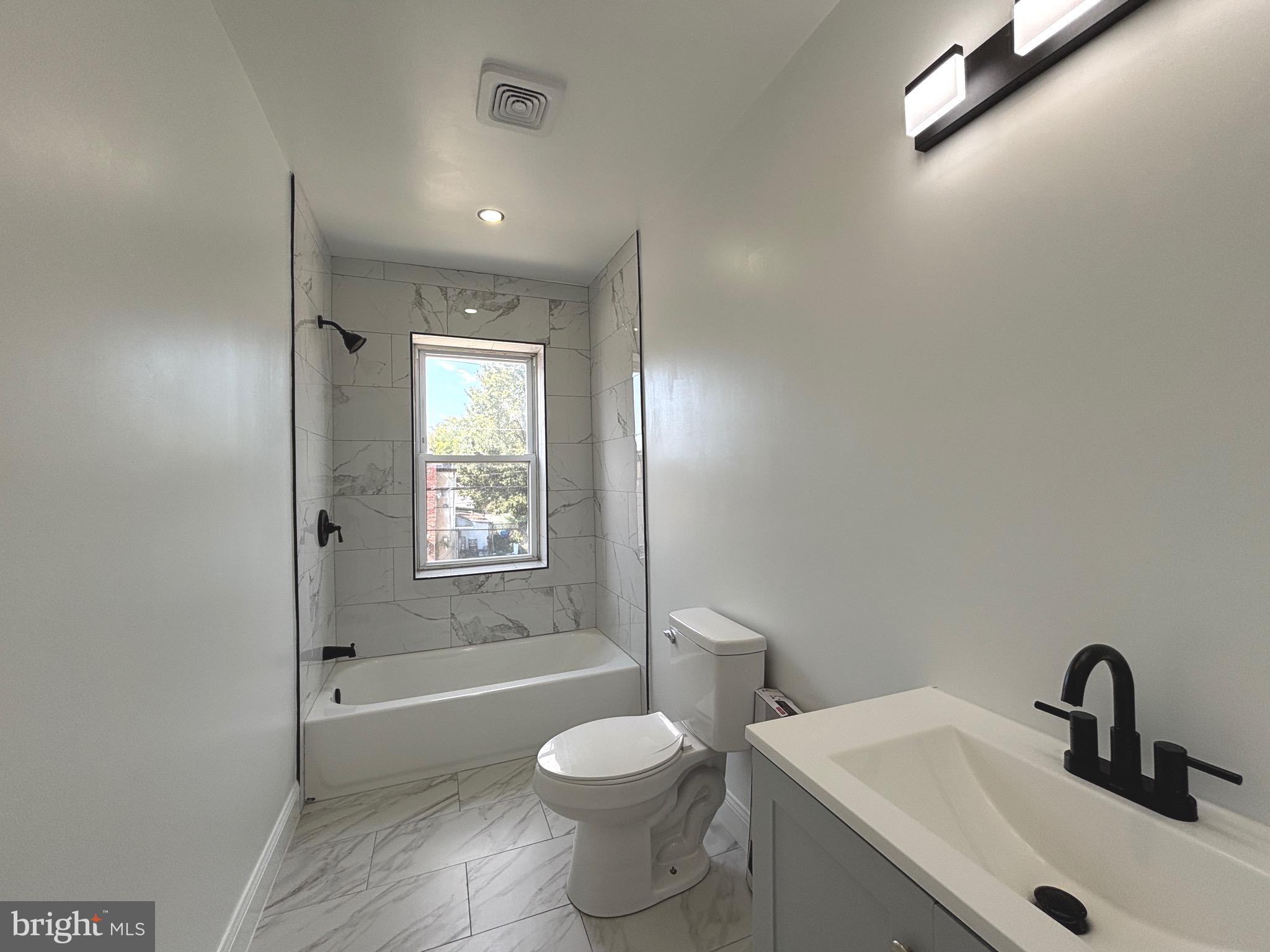 2636 Harford Road Baltimore, MD 21218 - Photo 12 of 18 a bathroom with a sink toilet and shower