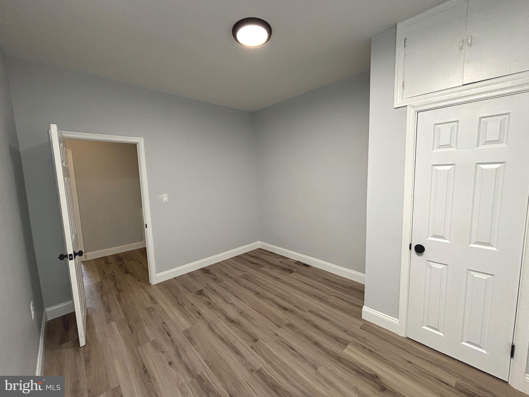 2636 Harford Road Baltimore, MD 21218 - Photo 17 of 18 an empty room with wooden floor and closet