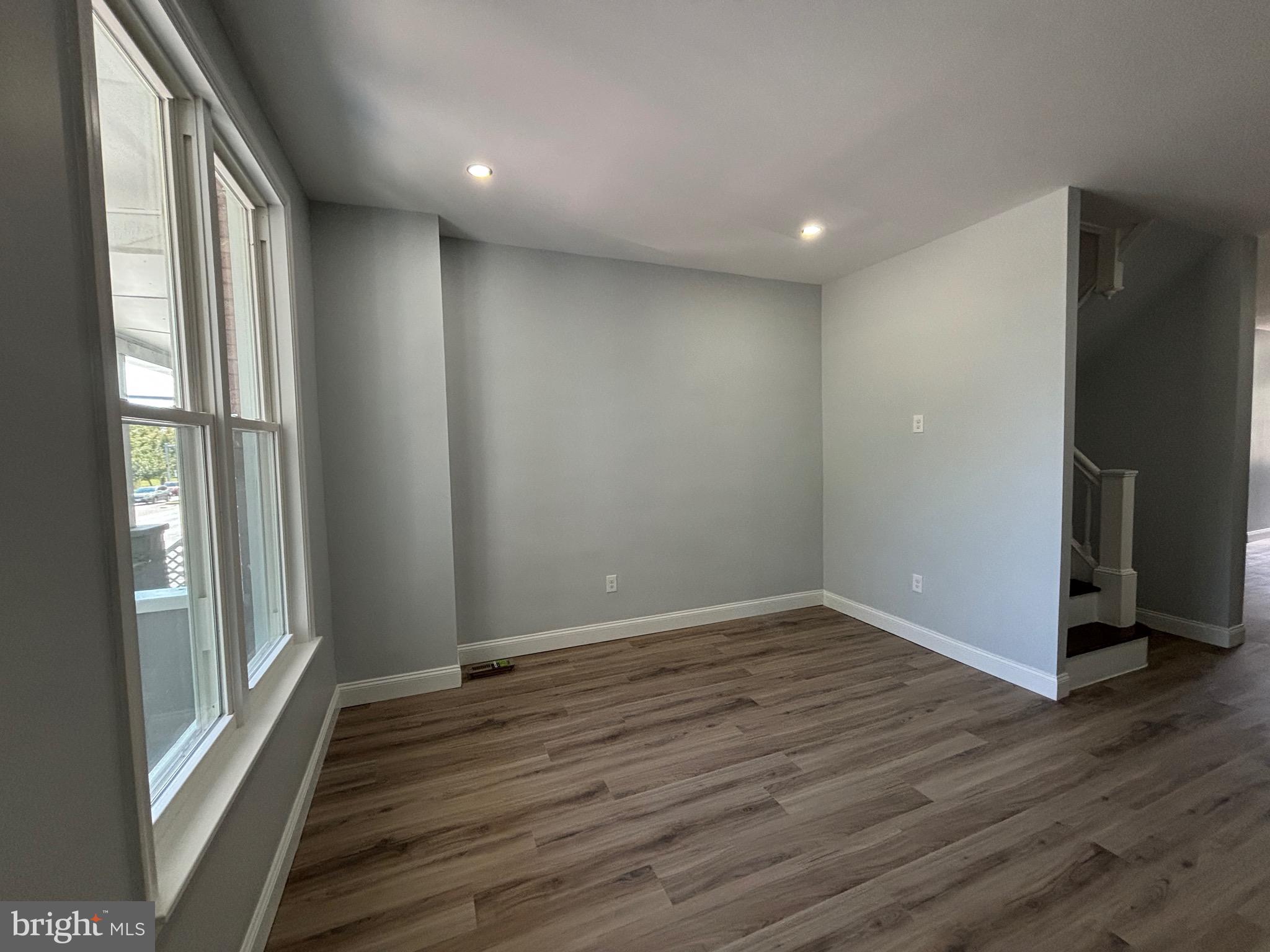 2636 Harford Road Baltimore, MD 21218 - Photo 4 of 18 a view of an empty room with wooden floor and a window