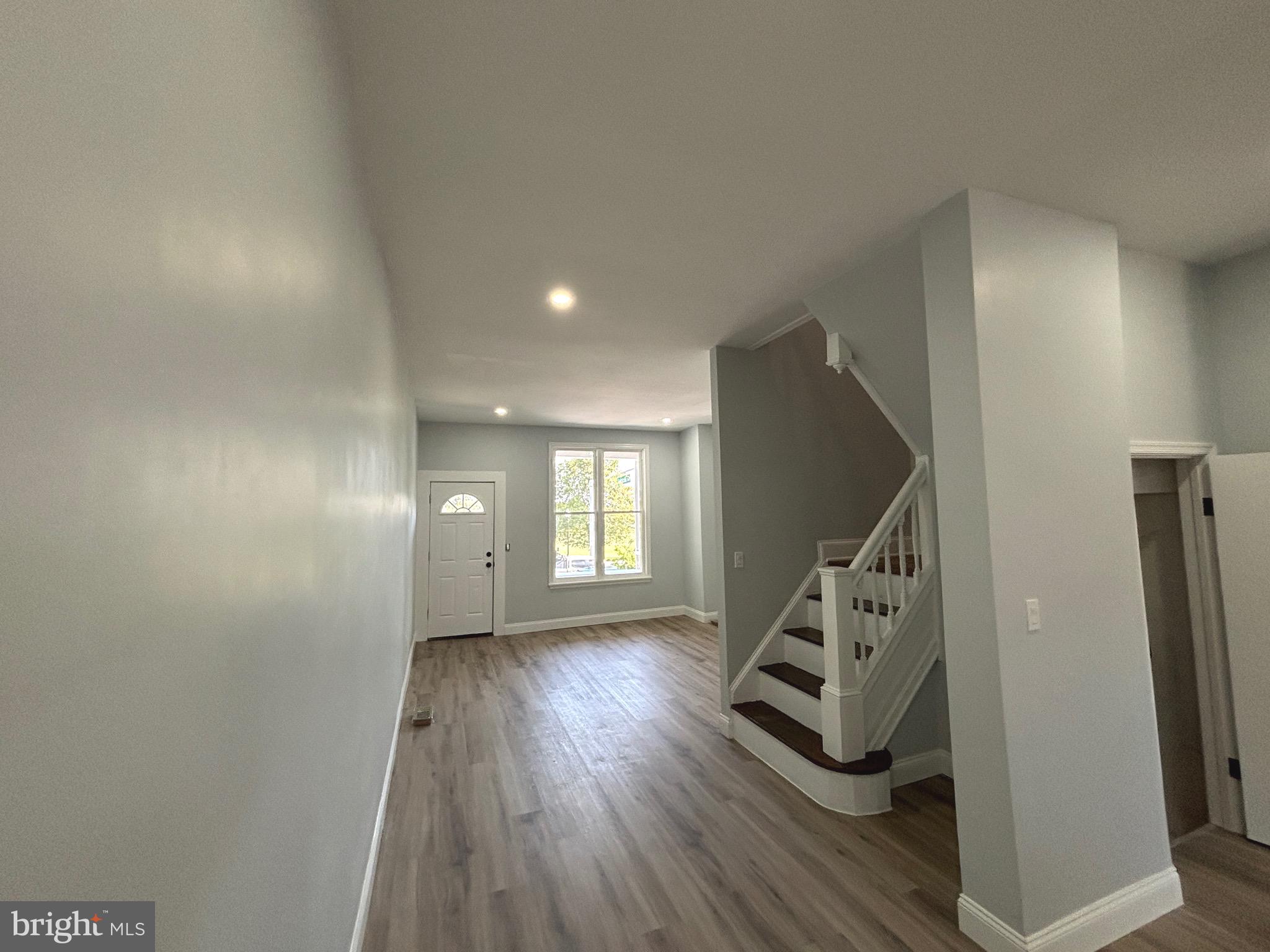 2636 Harford Road Baltimore, MD 21218 - Photo 6 of 18 a view of a hallway with wooden floor and stairs