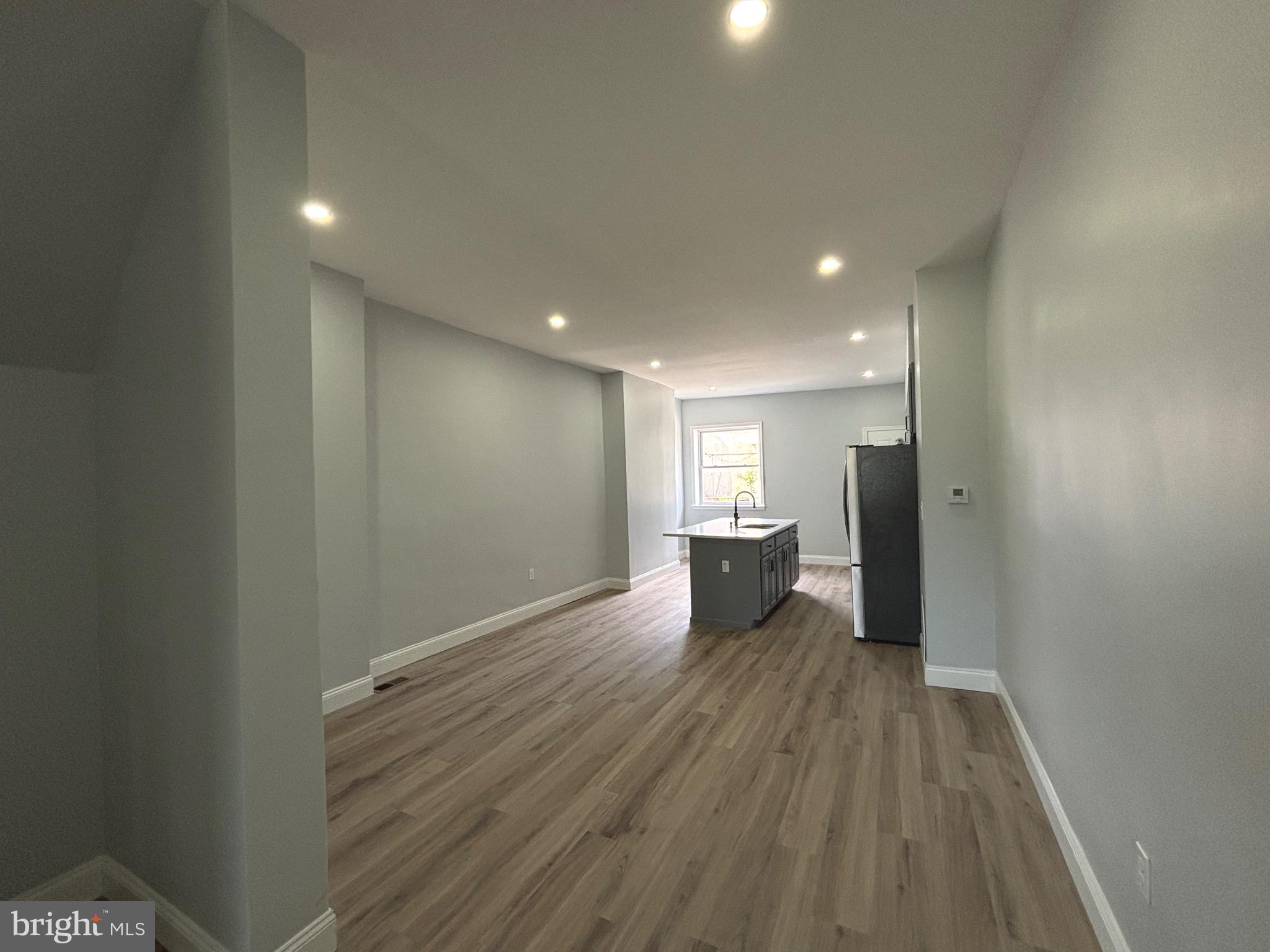 2636 Harford Road Baltimore, MD 21218 - Photo 7 of 18 a view of a big room with wooden floor and windows