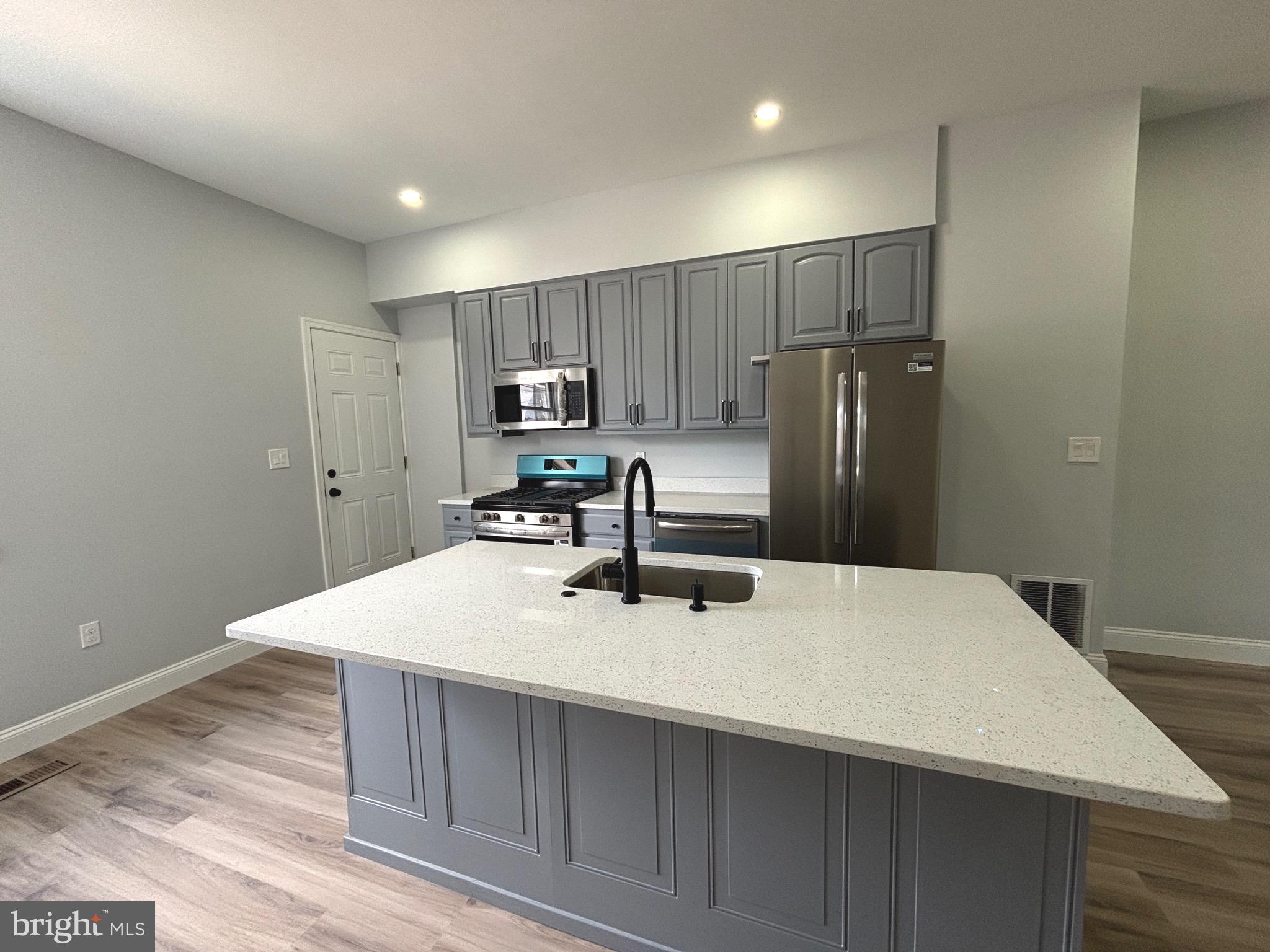2636 Harford Road Baltimore, MD 21218 - Photo 8 of 18 a kitchen with kitchen island a sink appliances and cabinets