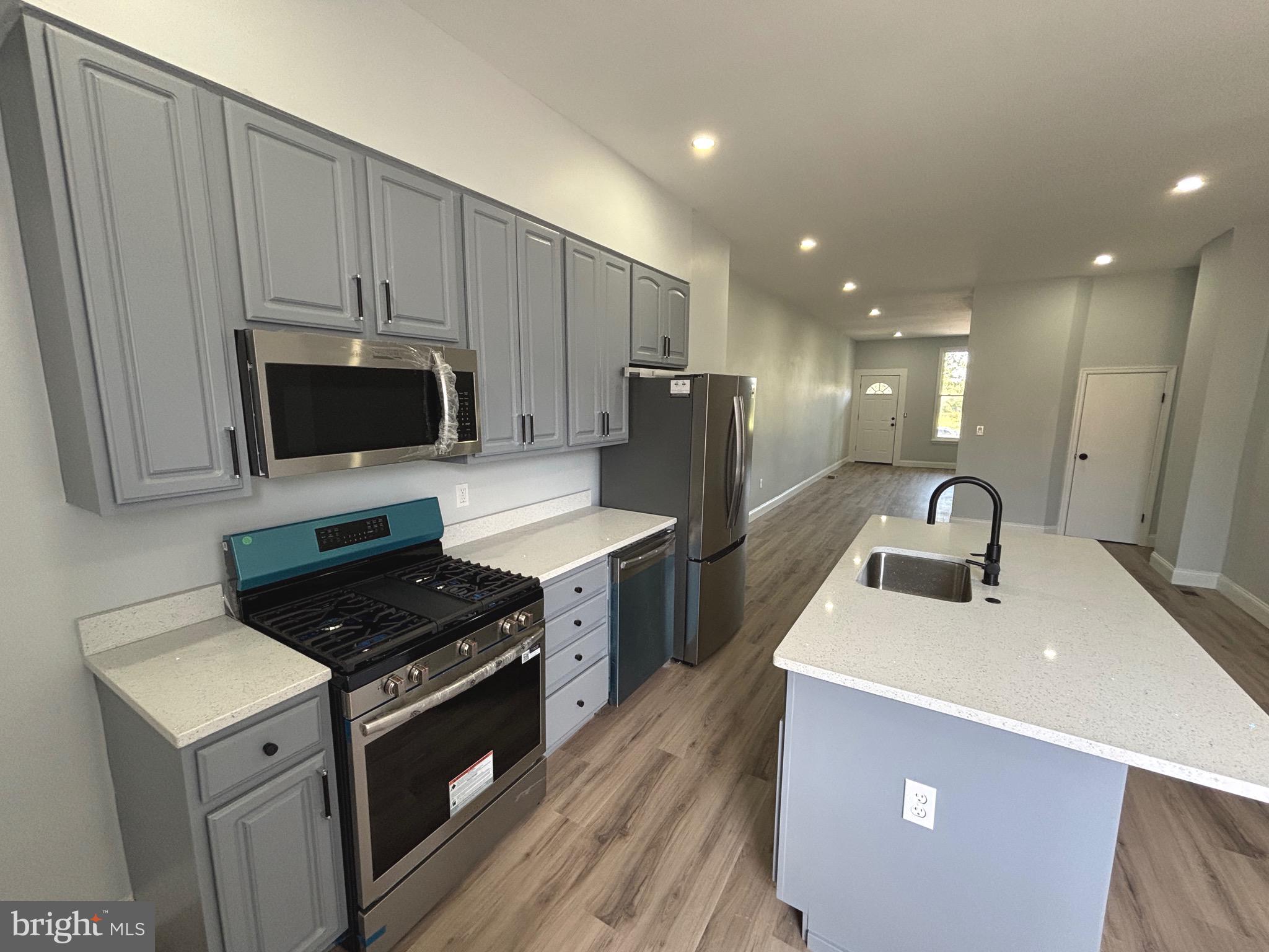 2636 Harford Road Baltimore, MD 21218 - Photo 9 of 18 a kitchen with a sink a stove and refrigerator