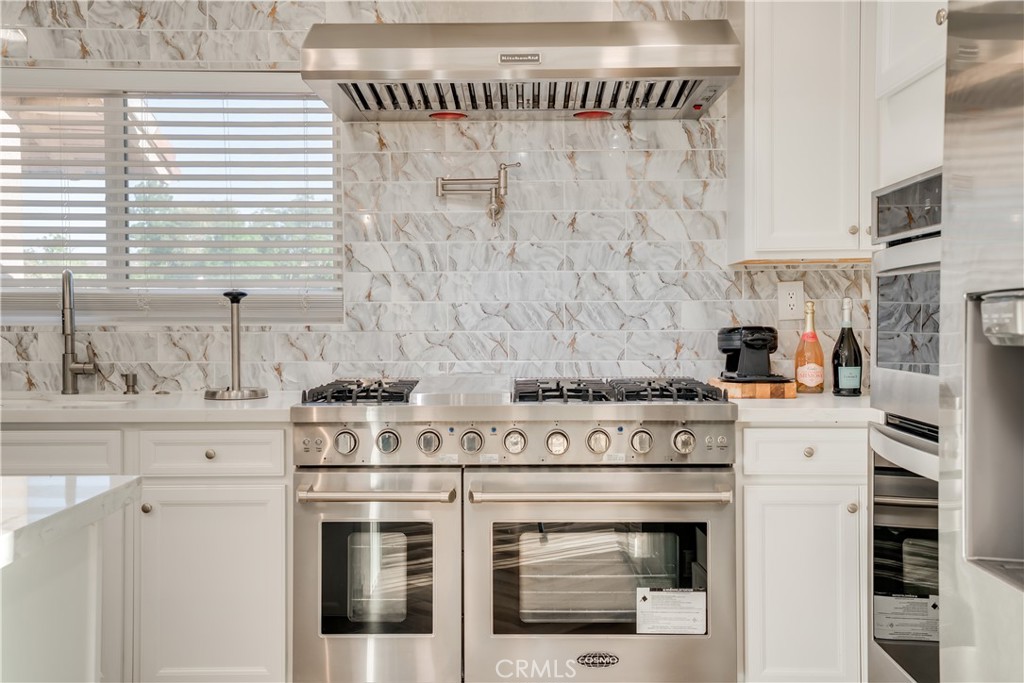 1450 Vía Vallarta Riverside, CA 92506 - Photo 16 of 36 a white stove top oven sitting inside of a kitchen
